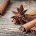 Star anise and cinnamon sticks on wooden table.