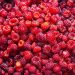 Fresh ripe raspberries piled together.
