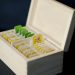 Assorted tea bags organized in a wooden box.