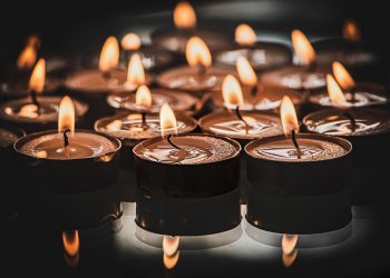 Burning tealight candles creating a warm, ambient glow.
