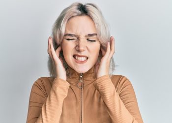 Woman covering ears in frustration.