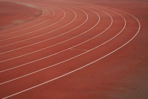 Running track curves with lane lines.