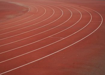 Running track curves with lane lines.