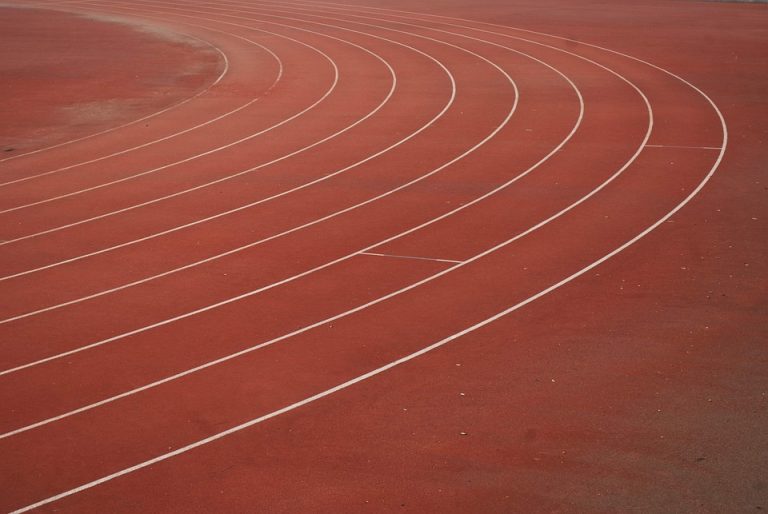 Running track curves with lane lines.