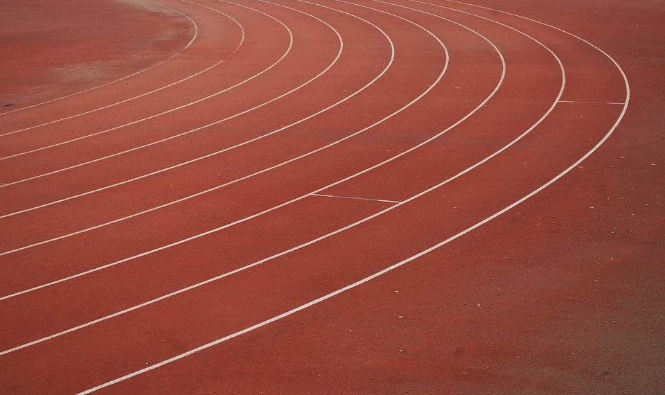 Running track curves with lane lines.