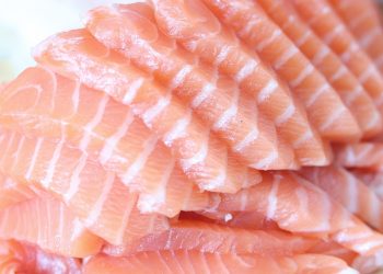 Slices of fresh salmon fillet neatly stacked.