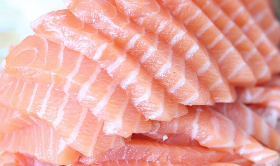 Slices of fresh salmon fillet neatly stacked.