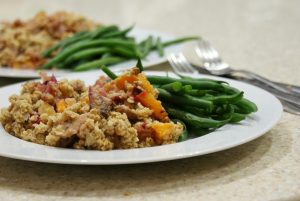 Scrambled tofu with colorful veggies and green beans on a white plate.