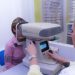 Eye exam with autorefractor machine in optometry clinic.