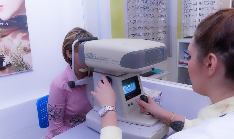 Eye exam with autorefractor machine in optometry clinic.