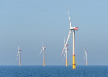 Wind turbines generating power in the ocean.