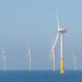 Wind turbines generating power in the ocean.