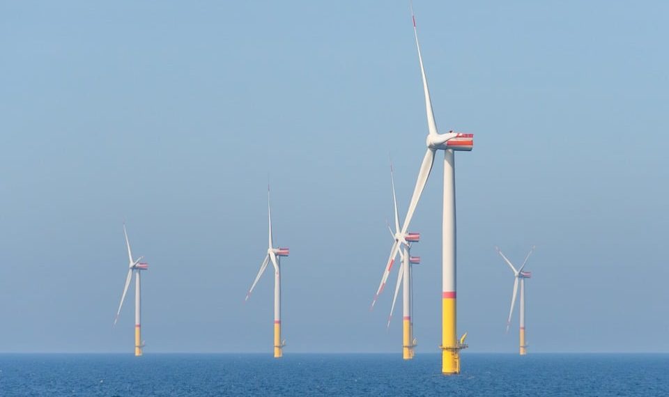 Wind turbines generating power in the ocean.