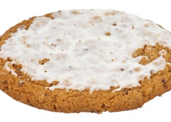 Frosted oatmeal cookie on white background.