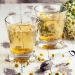 Chamomile tea in glasses with fresh chamomile flowers.