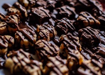 Drizzled chocolate cookies arranged in rows.