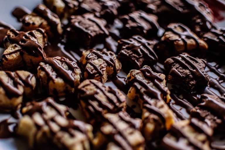 Drizzled chocolate cookies arranged in rows.