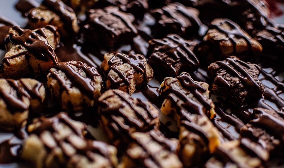 Drizzled chocolate cookies arranged in rows.