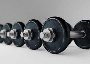 Row of heavy dumbbells on a smooth surface.