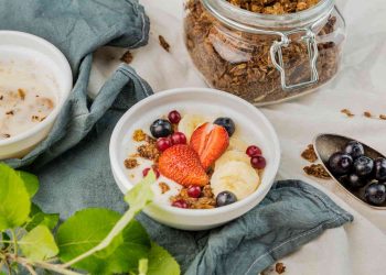 Granola bowl with strawberries, bananas, and blueberries.