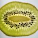Sliced kiwi fruit showing seeds and green texture.