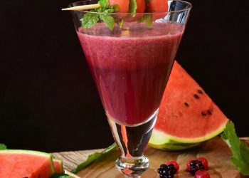 Fresh watermelon smoothie garnished with mint leaves.