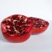 Half pomegranate showcasing vibrant red seeds.