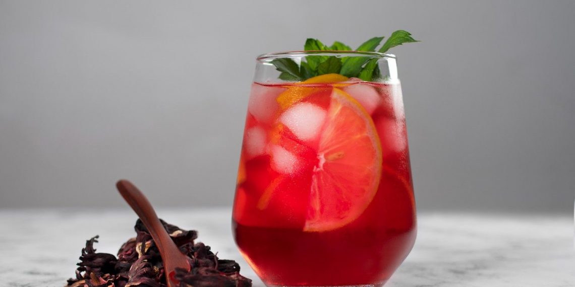 Chilled hibiscus iced tea with citrus slices and mint.