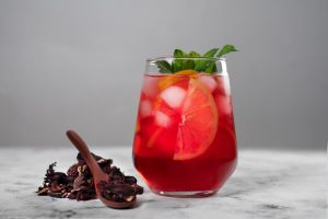 Chilled hibiscus iced tea with citrus slices and mint.