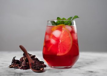 Chilled hibiscus iced tea with citrus slices and mint.