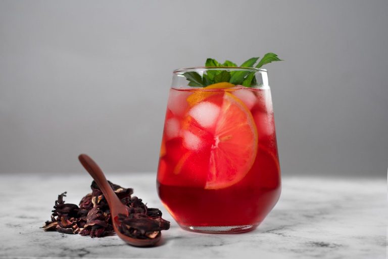 Chilled hibiscus iced tea with citrus slices and mint.