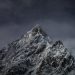 Snow-covered mountain peak under a starry sky.