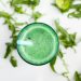 Green smoothie with mint leaves and a blue straw