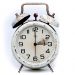 Rustic vintage alarm clock with weathered finish.