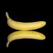 Banana with reflection on black background.