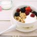 Yogurt bowl with granola, strawberries, raspberries, and blackberries.