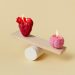 Heart and brain candles balancing on a wooden plank.
