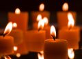 Floating candles creating a warm glow in the dark ambiance.