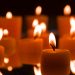 Floating candles creating a warm glow in the dark ambiance.
