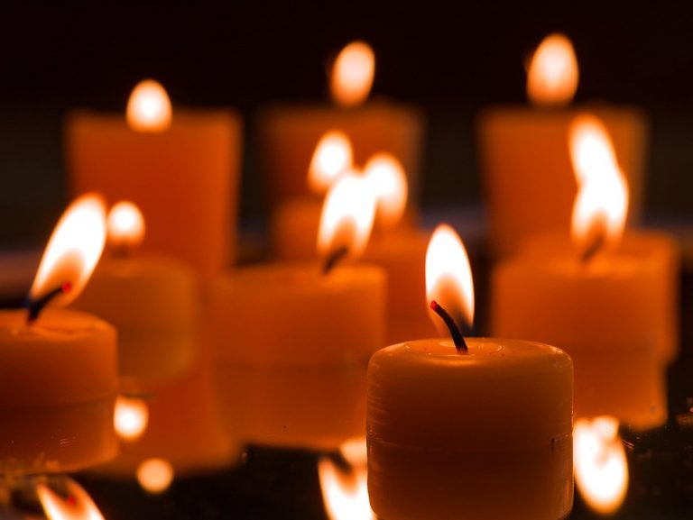 Floating candles creating a warm glow in the dark ambiance.