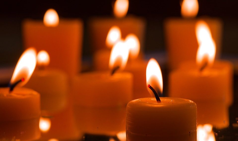 Floating candles creating a warm glow in the dark ambiance.