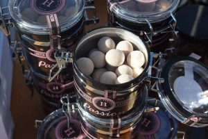 Luxury candy jars filled with round sweets, branded Passion.
