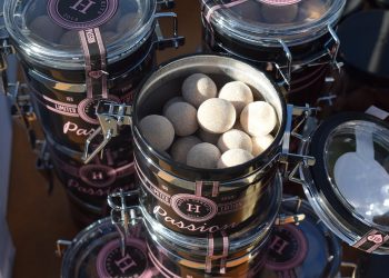 Luxury candy jars filled with round sweets, branded Passion.
