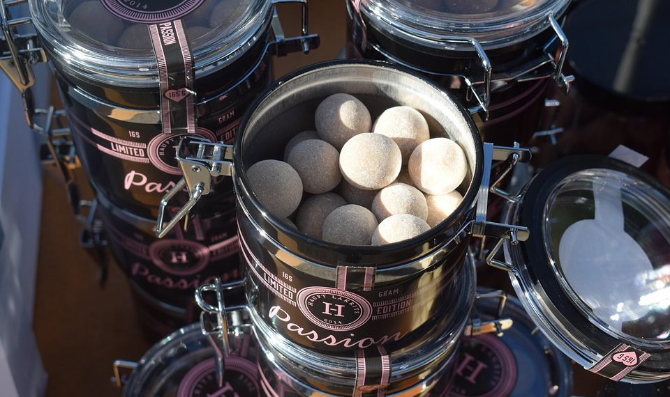 Luxury candy jars filled with round sweets, branded Passion.