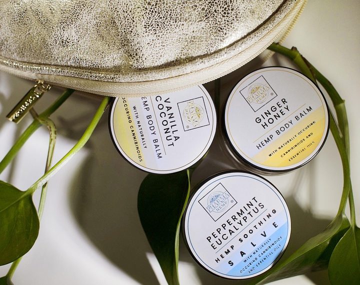 Hemp body balms with natural ingredients in a pouch.