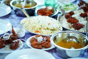 Variety of Indian dishes on a table ready to serve.