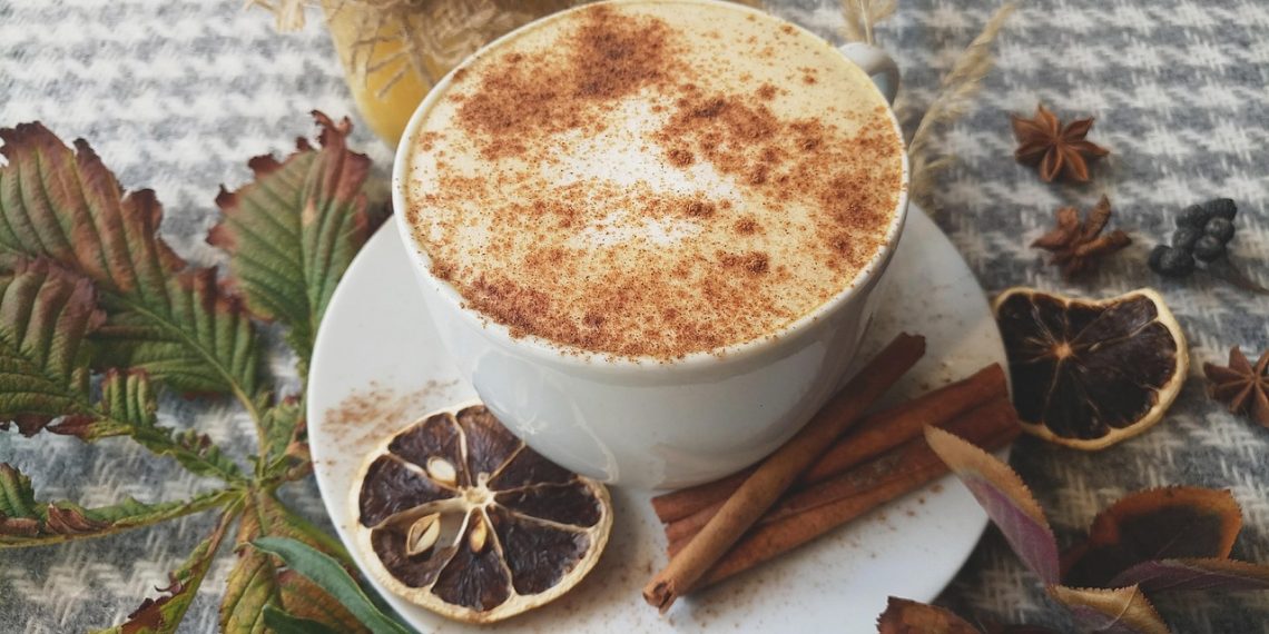 Creamy spiced latte with cinnamon and dried orange.