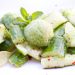 Cucumber salad garnished with a mint sorbet and lime slices.