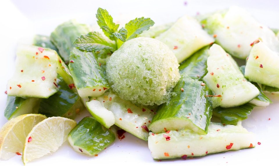 Cucumber salad garnished with a mint sorbet and lime slices.