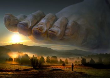 Giant stone foot hovering over misty landscape at sunrise.